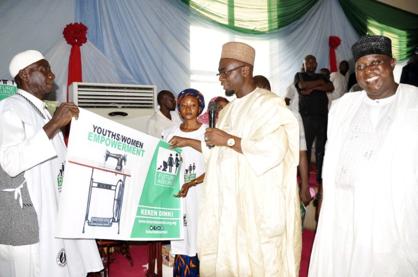 Aisha-Buhari-beneficiaries-of-sewing-machine-Zakari-Sale-and-Irange-Wachap-being-presented-by-Senator-Abubakar-Tutare.jpg