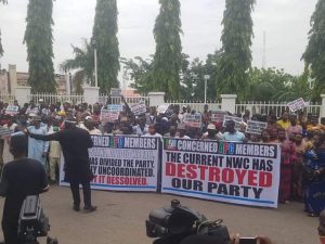 Dissolve APC’s NWC now! Protesters demand as they match in Party Secretariat in Abuja
